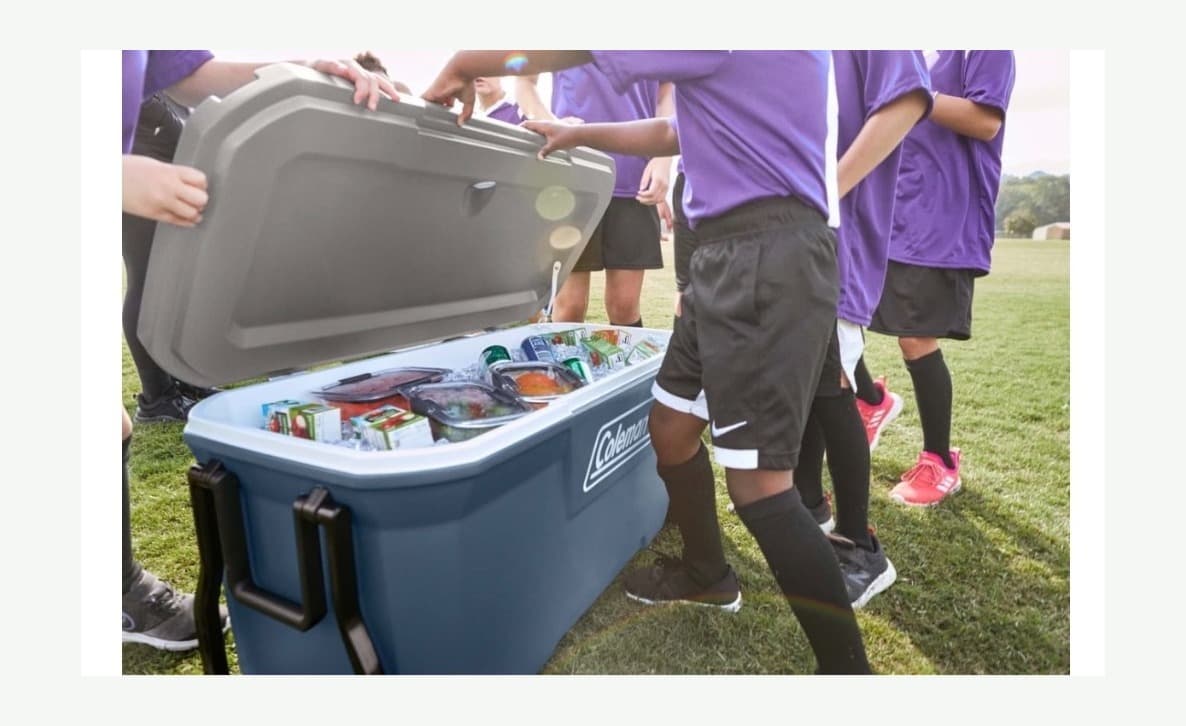 Team Dugout Kit large cooler setup with youth players on a sports field